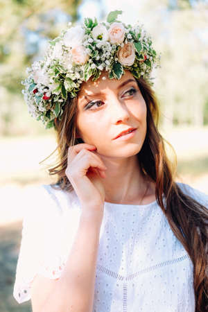 Tender young caucasian woman wearing white wreath. Wedding guest.の写真素材