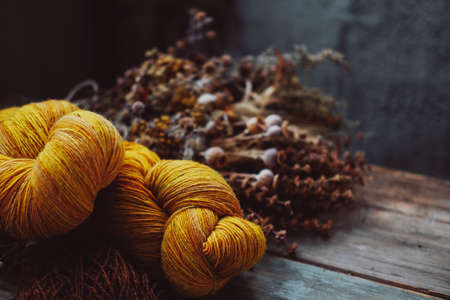 Bright yellow wool yarn skeins in rusticの写真素材