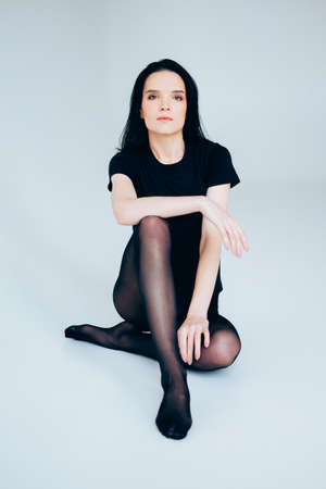 Young adult woman posing wearing total black. Casual outfit.の写真素材