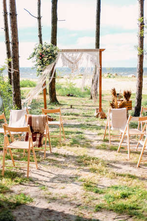 Wedding on the beach. Arch for guests and newly weds in pine forest.の写真素材