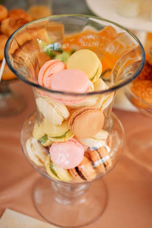 Sweet colorful macaroon cookies served on a glass plate. Candy bar concept.の写真素材