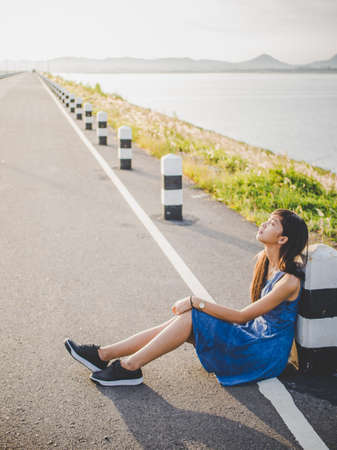 Beautiful girl Sitting on the  roadの写真素材