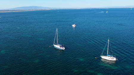 Aerial view of two sailboats in the blue sea water.の写真素材