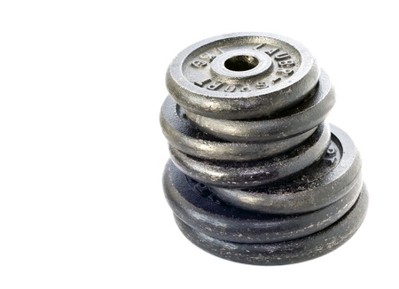 dumbbell weights stacked and isolated on whiteの写真素材