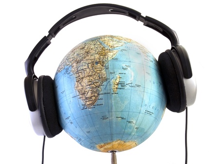 Globe with headphones on white backgroundの写真素材