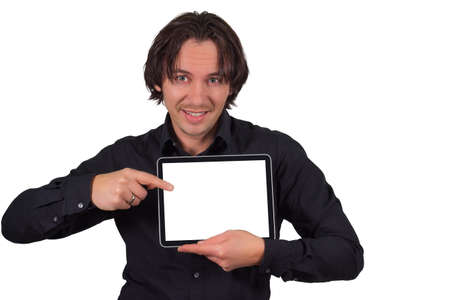 Cheerful young man holding a Pc tablet and pointing to its blank screen, portraitの写真素材