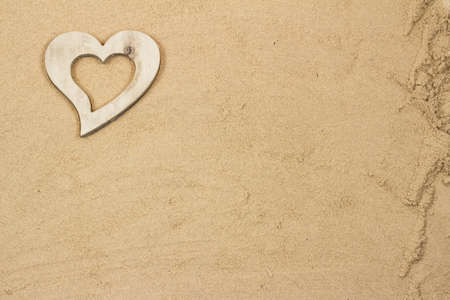 Handmade heart in the sand with copy space の写真素材