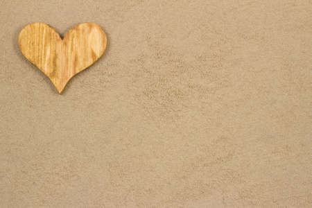 Handmade heart in the sand with copy space の写真素材