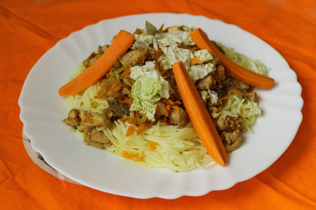 rice noodles poultry meat and vegetables on white plate viewの写真素材