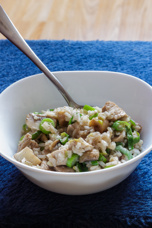 Pork and mushroom Stroganoff with rice on a blue background vertical viewの写真素材