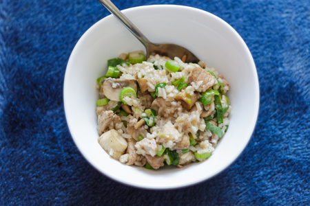 Pork with rice and mushrooms on a blue background Top Viewの写真素材