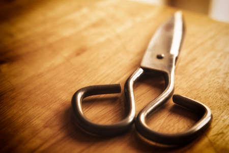 old scissors on the wooden backgroundの写真素材
