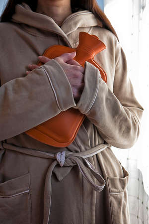 Woman with hot water bagの写真素材
