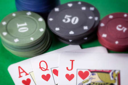 Poker chips and cards on green