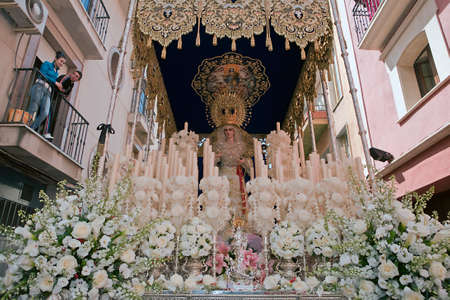Front with candles, embroidered fabric and flowers of the throne of the Nuestra Seora del Amor Hermoso, Linares, Jaen province, Spainのeditorial素材