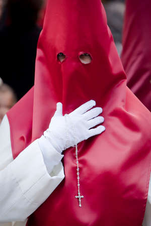 Penitent with a rosary in his hand in a procession, Spainのeditorial素材