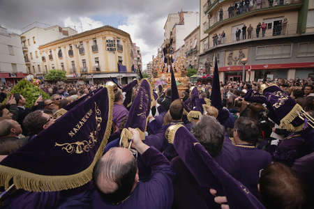 Penitents to playing their trumpets in a Holy week procession to the Nazarene, Holy Friday, Linares,...