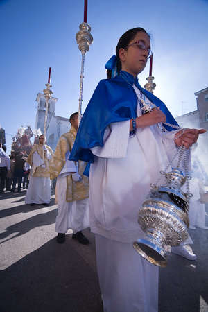 Young people in procession with incense burners in Holy week, Spain