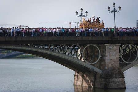  Brotherhood of San Gonzalo passing the holy Monday by the Puente de Triana, Seville, Spainのeditorial素材