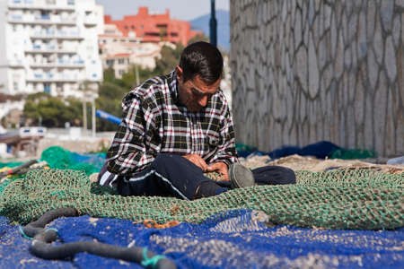 Sailor fixed their fishing nets in the port of Estepona, province of malaga, Spainのeditorial素材