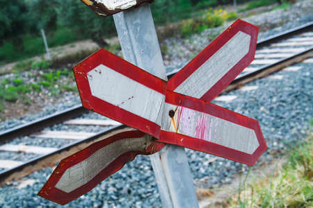 Warning sign worn of level crossing without barriers, blue sky with clouds