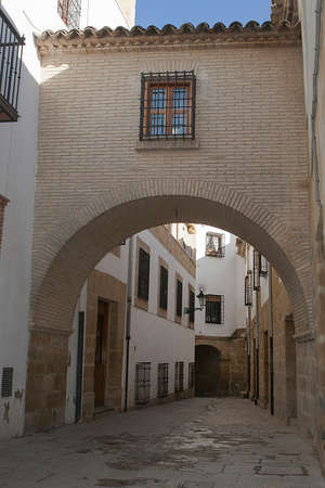 Typical Street of the world heritage city in Baeza, Street Barbacana next to the clock tower, It is characterized by the union of two houses with a passage, Baeza, Jaen province, Andalucia, Spainのeditorial素材