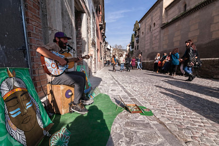  Granada, SPAIN - 16 february 2013  Musician playing for a few coins in the carrera del Darro on a Sunday afternoon, Granada, Spainのeditorial素材