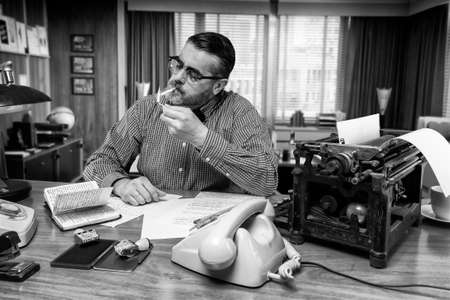 Man smoking a cigarette while work in the office, 1960の写真素材
