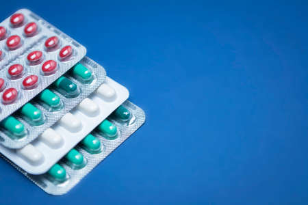 Some pills aligned isolated on blue 