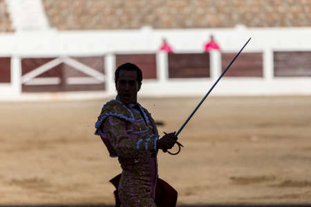 Silhouette of a bullfighter with sword aloft after fight in the arenaのeditorial素材