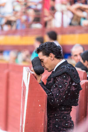 Bullfighter with montera starting rite of praying before bullfight, Spainのeditorial素材