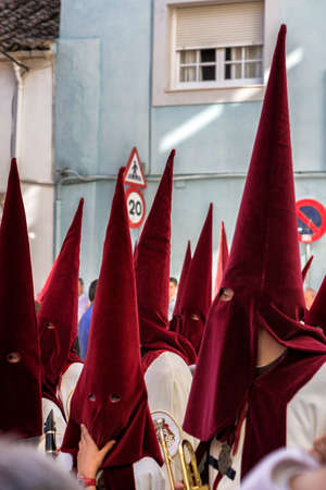 Penitents playing trumpets during Holy week in the good Friday procession, take in Linares, Jaen province, Spainのeditorial素材