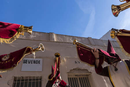 Penitents playing trumpets during Holy week in the good Friday procession, take in Linares, Jaen province, Spainのeditorial素材