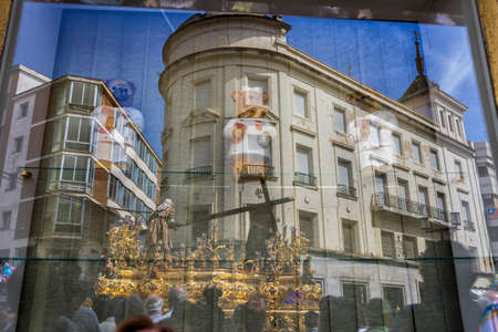 Reflection in a window of Holy week in the good Friday procession, Spain