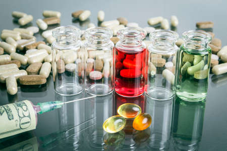 small bottles with pills along with a syringe, concept of sanitary copayment
