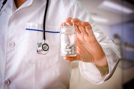 Close-up of doctor holding a pill containerの写真素材
