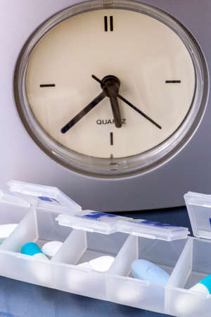 some pills in a pillbox, daily medication treatmentの写真素材