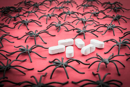 Spiders around capsules, concept phobia to medicinesの写真素材