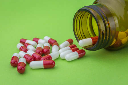 Pills spilling from an open bottleの写真素材