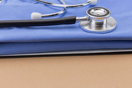 stethoscope and a book on brown backgroundの写真素材