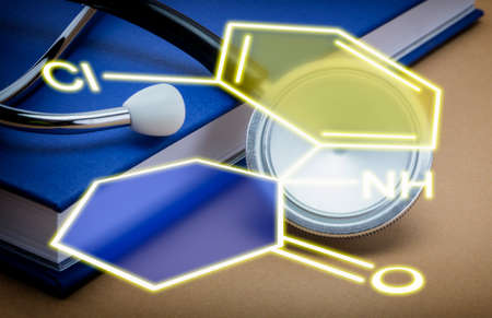 stethoscope and a book on brown background, Chemical formula