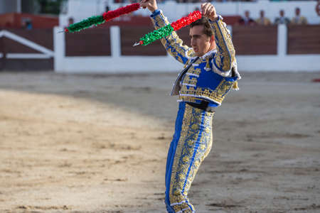 Linares, Spain - August 28, 2014: The Spanish Bullfighter David Fandila El Fandi with flags in each hand, classic of the taurine art movement in the Bullring of Linares, Spainのeditorial素材