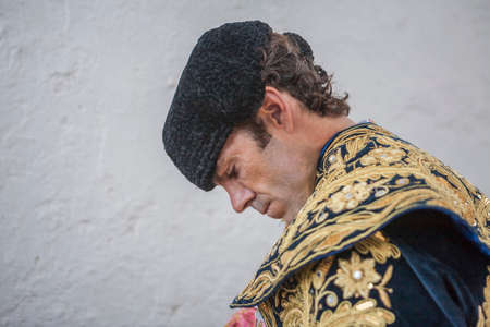 Linares, SPAIN - August 29 2014: Spainish bullfighter Jose Tomas putting itself the walk cape in the alley before going out to bullfight, typical and very ancient tradition in Linares,  Jaen province, Spainのeditorial素材