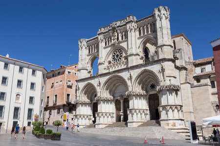 CUENCA, SPAIN - APRIL 2, 2016: Tourists walk near the facade of the Cuenca's Cathedral, The cathedral is dedicated to St Julian, gothic english-norman style, XII century, called the Basilica of Our Lady of Graceのeditorial素材