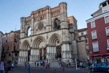 CUENCA, SPAIN - APRIL 2, 2016: Tourists walk near the facade of the Cuenca's Cathedral, The cathedral is dedicated to St Julian, gothic english-norman style, XII century, called the Basilica of Our Lady of Graceのeditorial素材