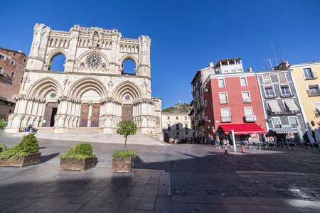 CUENCA, SPAIN - APRIL 2, 2016: Tourists walk near the facade of the Cuenca's Cathedral, The cathedral is dedicated to St Julian, gothic english-norman style, XII century, called the Basilica of Our Lady of Graceのeditorial素材