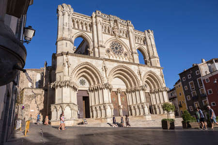 CUENCA, SPAIN - APRIL 2, 2016: Tourists walk near the facade of the Cuenca's Cathedral, The cathedral is dedicated to St Julian, gothic english-norman style, XII century, called the Basilica of Our Lady of Graceのeditorial素材