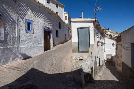 Alcala del Jucar, Spain - October 29, 2016: Narrow street with white painted houses, typical of this town, take in Alcala of the Jucar, Albacete province, Spainのeditorial素材