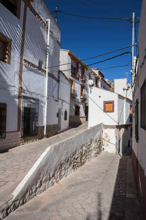 Alcala del Jucar, Spain - October 29, 2016: Narrow street with white painted houses, typical of this town, take in Alcala of the Jucar, Albacete province, Spainのeditorial素材