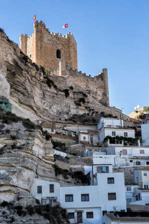 Alcala del Jucar, Spain - October 29, 2016: Side view of the village, on top of limestone mountain is situated Castle of the 12TH century Almohad origin, take in Alcala of the Jucar, Albacete province, Spainのeditorial素材